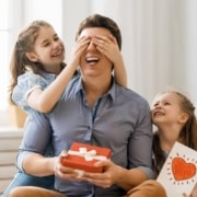 dad with his kids, who surprise him