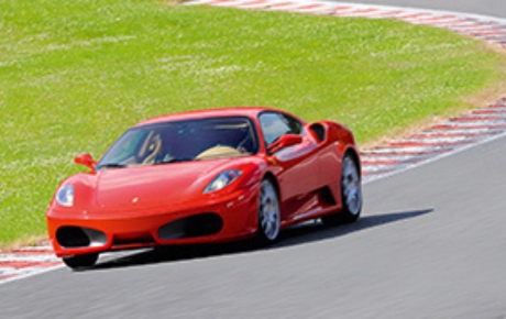 red ferrari on a racetrack